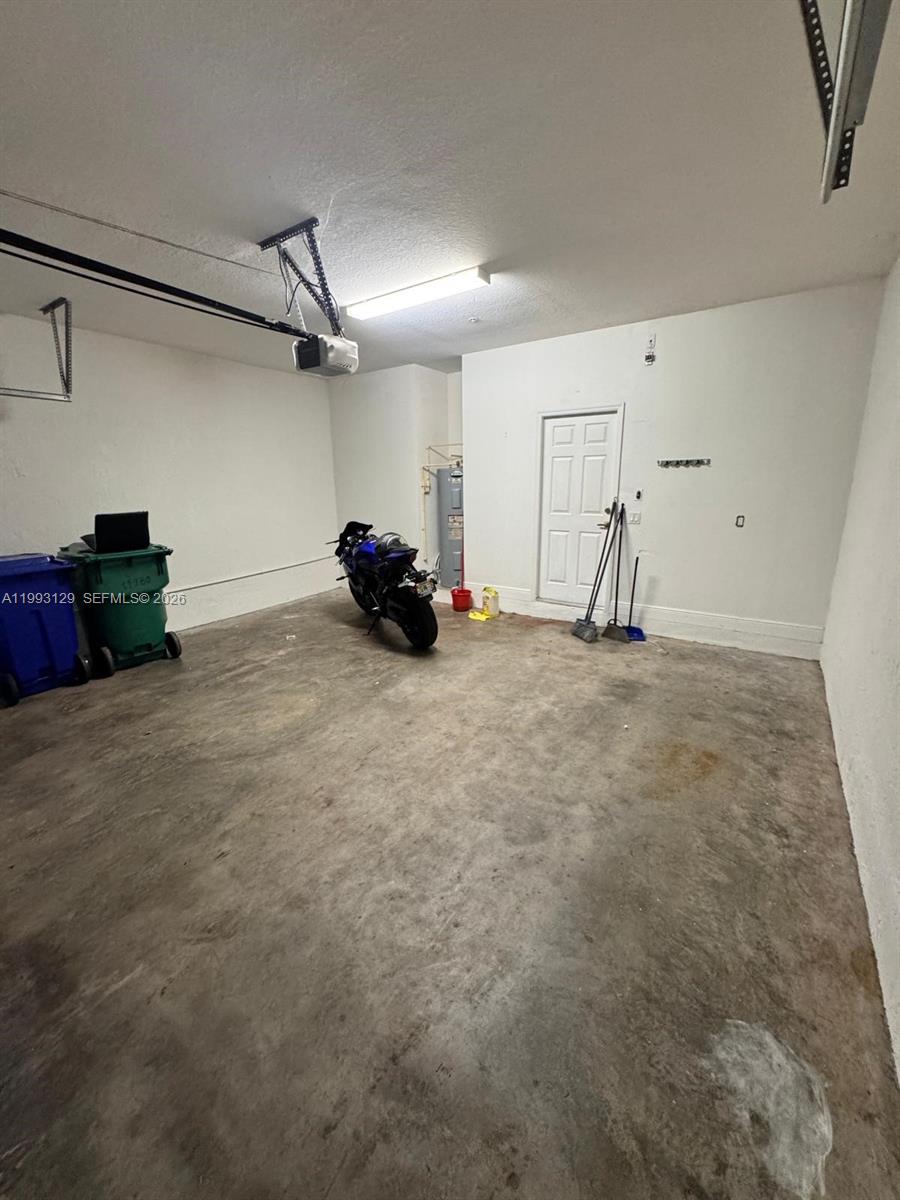 11980 Southwest 29th Street Miramar, FL 33025 - Photo 16 of 56 a view of a room with gym equipment and a chandelier