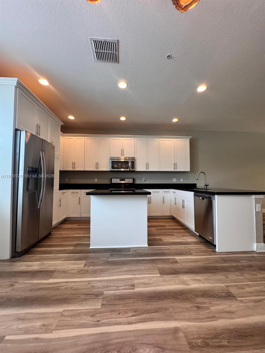 11980 Southwest 29th Street Miramar, FL 33025 - Photo 21 of 56 a view of kitchen with refrigerator and microwave