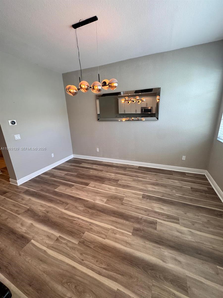 11980 Southwest 29th Street Miramar, FL 33025 - Photo 25 of 56 a view of a room with a ceiling fan and wooden floor