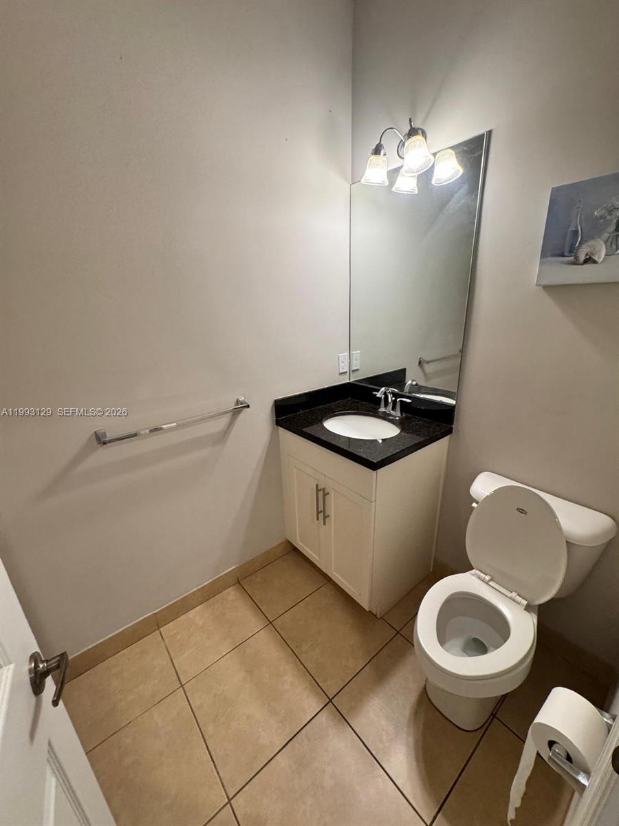 11980 Southwest 29th Street Miramar, FL 33025 - Photo 27 of 56 a bathroom with a sink a toilet and a mirror
