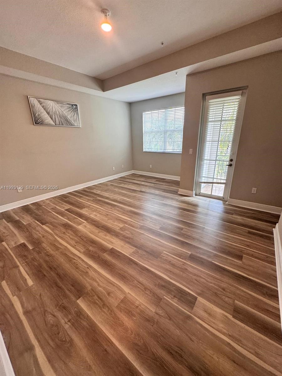 11980 Southwest 29th Street Miramar, FL 33025 - Photo 33 of 56 a view of an empty room with wooden floor and a window