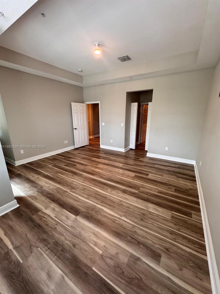 11980 Southwest 29th Street Miramar, FL 33025 - Photo 34 of 56 a view of an empty room with window and wooden floor