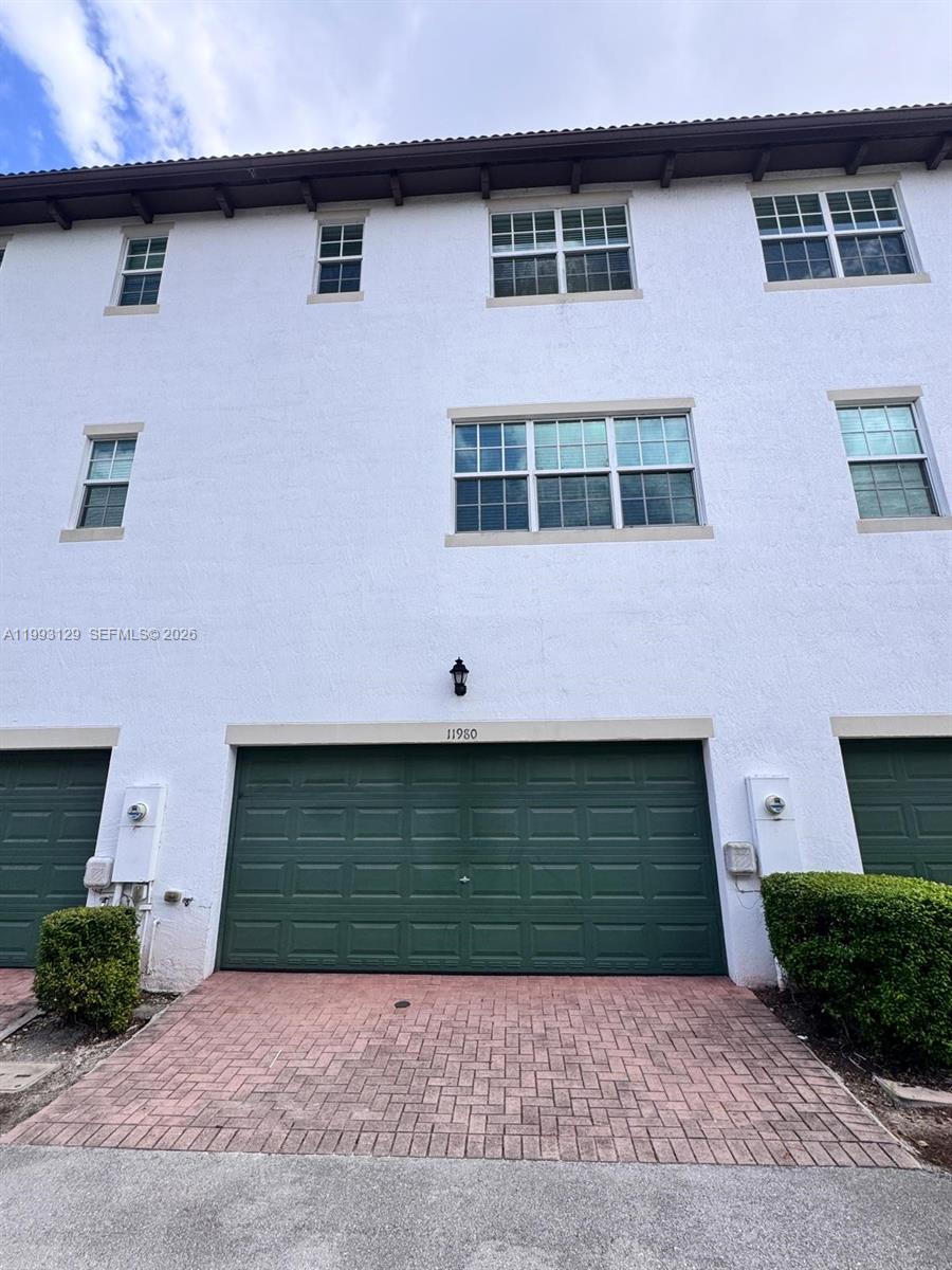 11980 Southwest 29th Street Miramar, FL 33025 - Photo 4 of 56 a front view of a house with garage