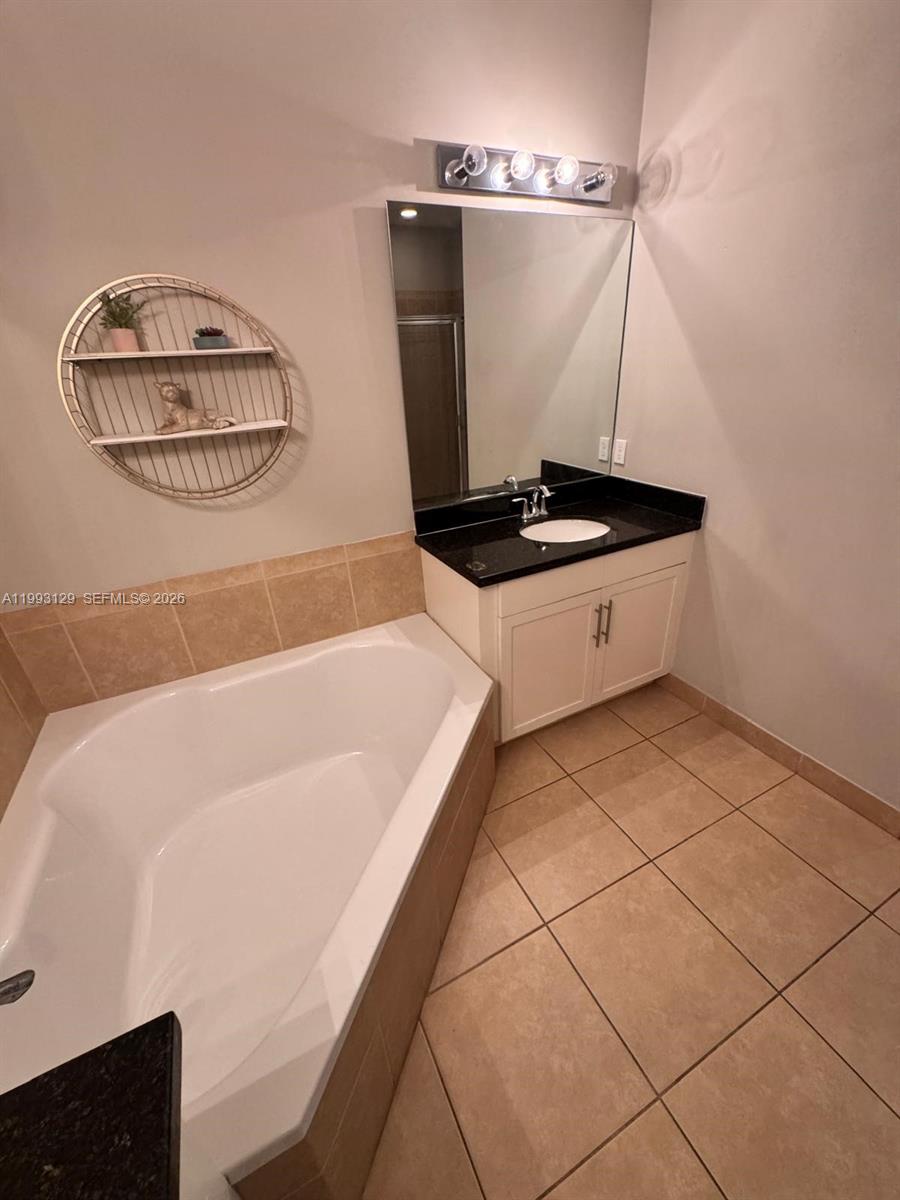 11980 Southwest 29th Street Miramar, FL 33025 - Photo 42 of 56 a bathroom with a tub and a shower