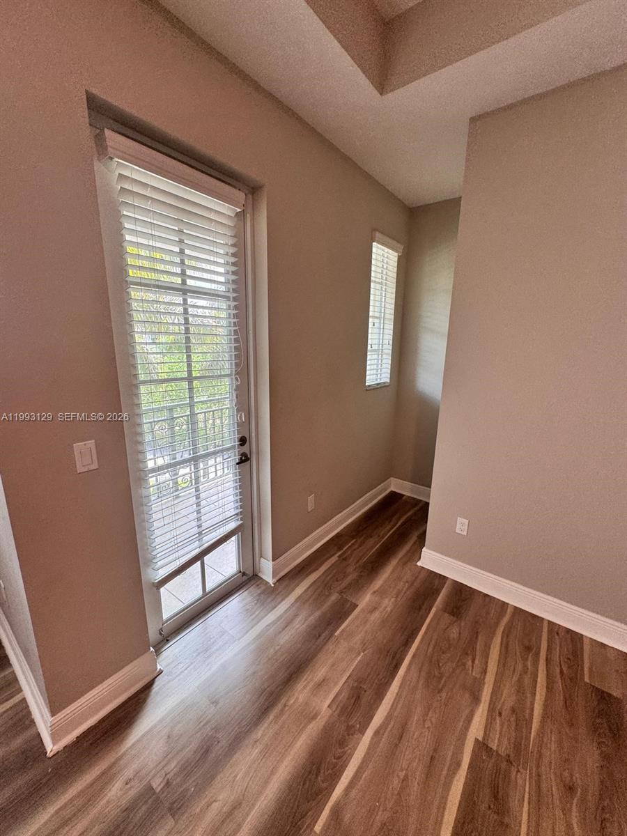 11980 Southwest 29th Street Miramar, FL 33025 - Photo 43 of 56 a view of an empty room with wooden floor and a window