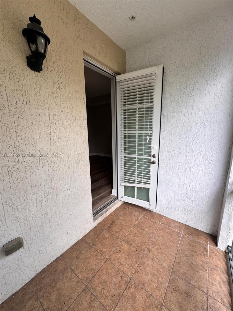 11980 Southwest 29th Street Miramar, FL 33025 - Photo 45 of 56 a view of an empty room with wooden floor and a window