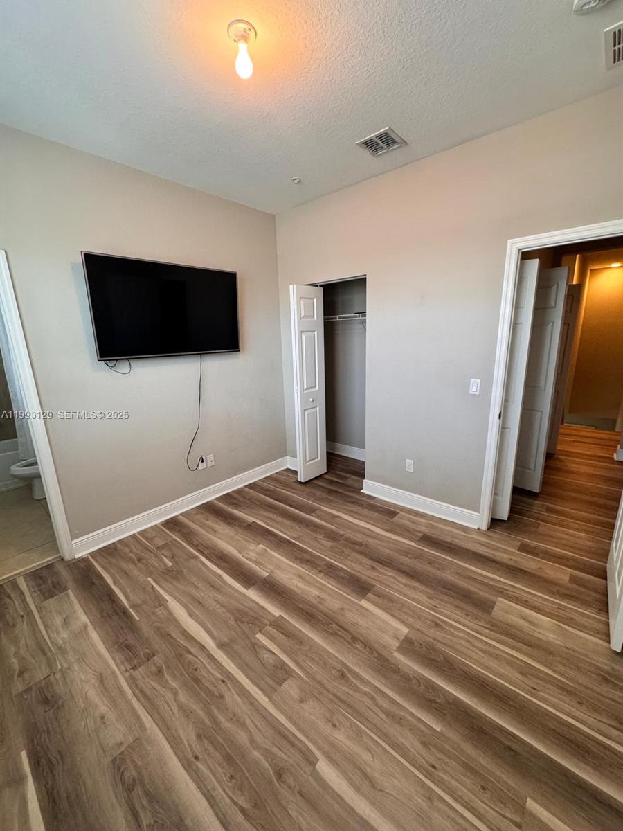 11980 Southwest 29th Street Miramar, FL 33025 - Photo 51 of 56 a bedroom with a bed and a flat screen tv