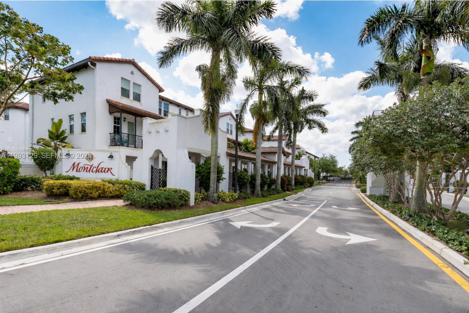 11980 Southwest 29th Street Miramar, FL 33025 - Photo 54 of 56 a view of a white house with a yard and potted plants
