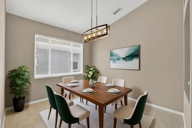 a view of a dining room with furniture a chandelier and wooden floor