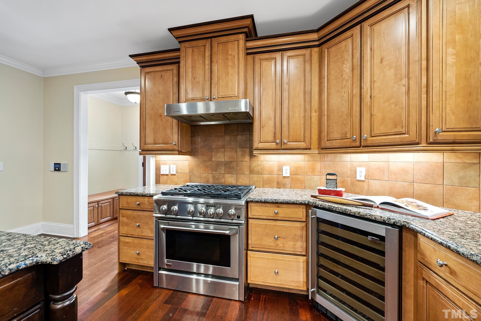 3044 Farrior Road Raleigh, NC 27607 - Photo 13 of 64 a kitchen with granite countertop a sink stainless steel appliances and cabinets