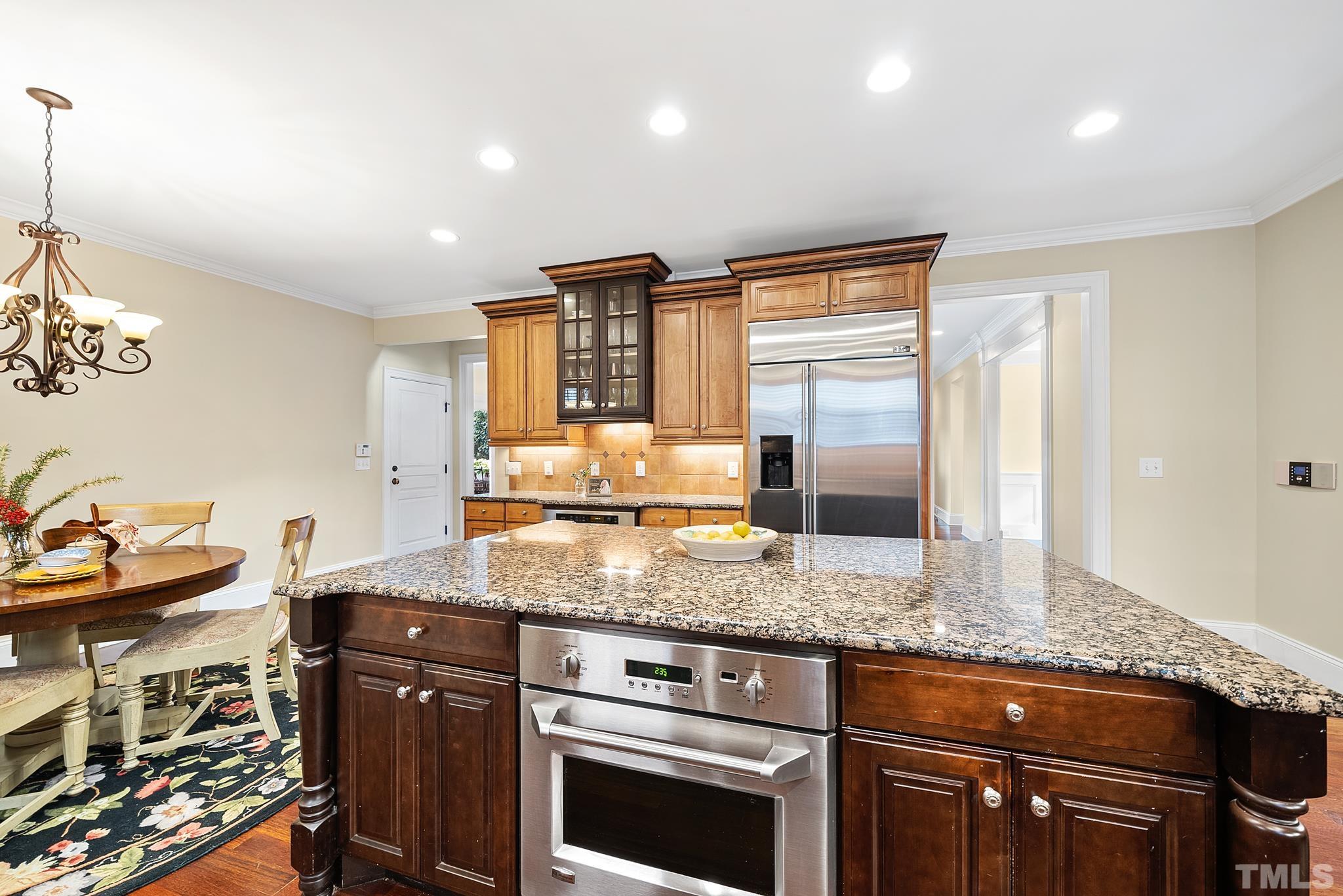 3044 Farrior Road Raleigh, NC 27607 - Photo 17 of 64 a kitchen with stainless steel appliances granite countertop a sink stove and cabinets