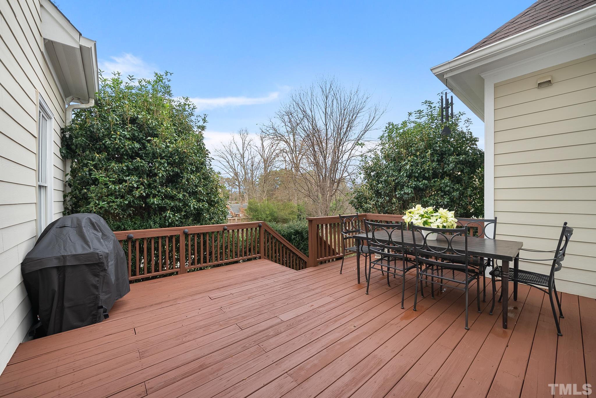 3044 Farrior Road Raleigh, NC 27607 - Photo 19 of 64 a view of a roof deck with table and chairs and wooden floor