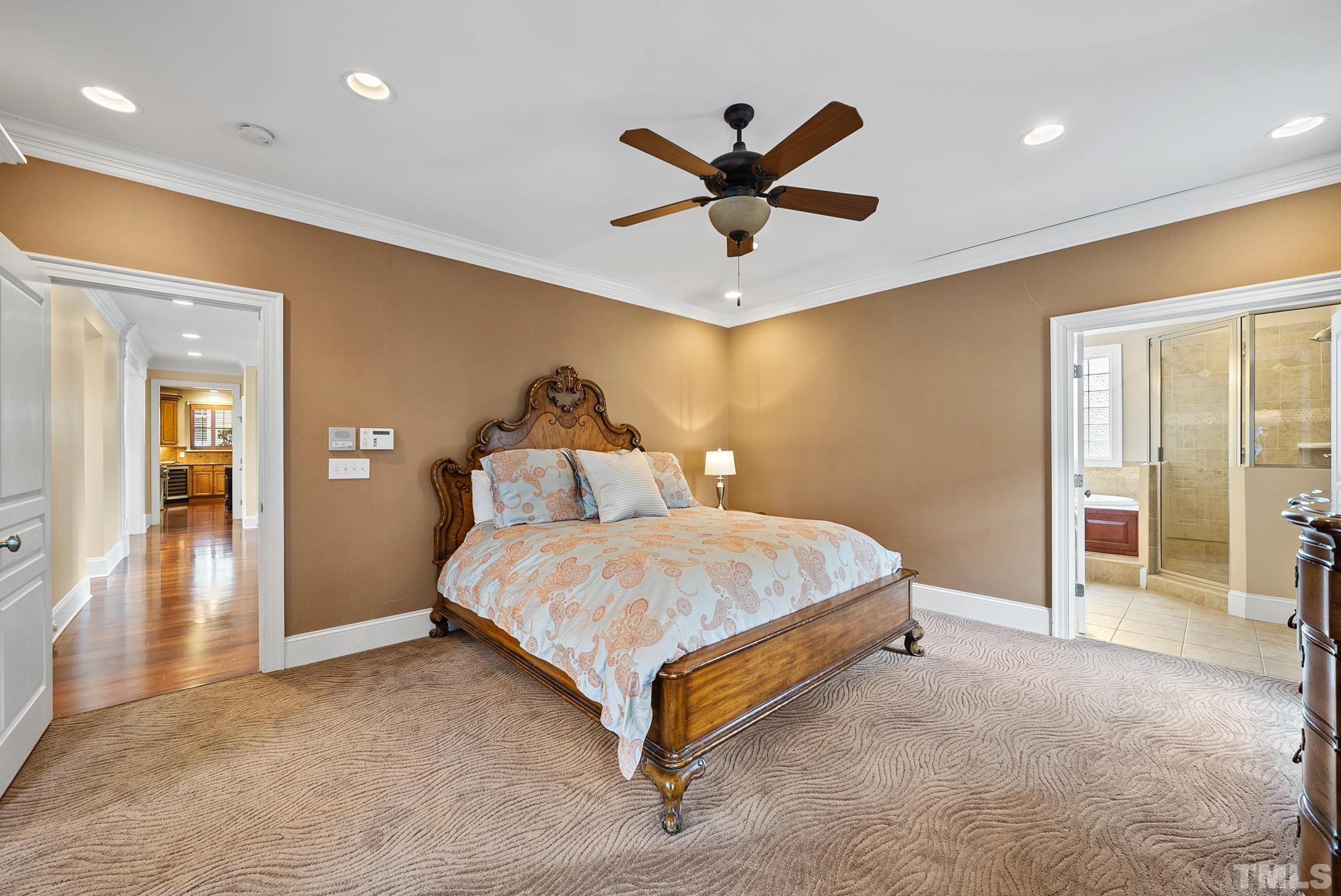3044 Farrior Road Raleigh, NC 27607 - Photo 22 of 64 a spacious bedroom with a bed and a chandelier