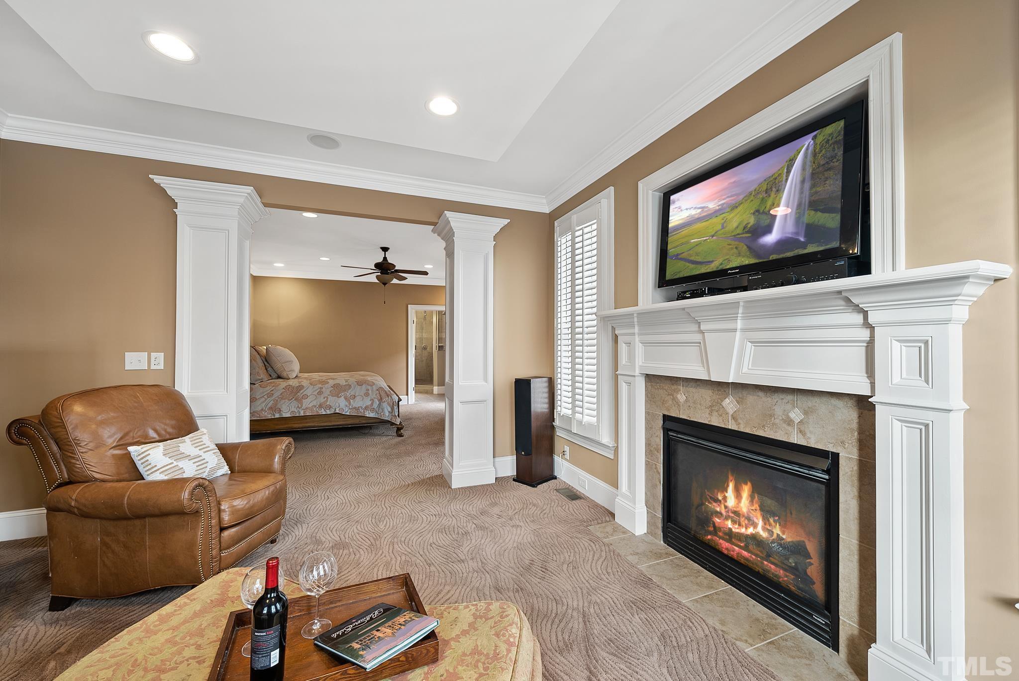 3044 Farrior Road Raleigh, NC 27607 - Photo 24 of 64 a living room with furniture a flat screen tv and a fireplace