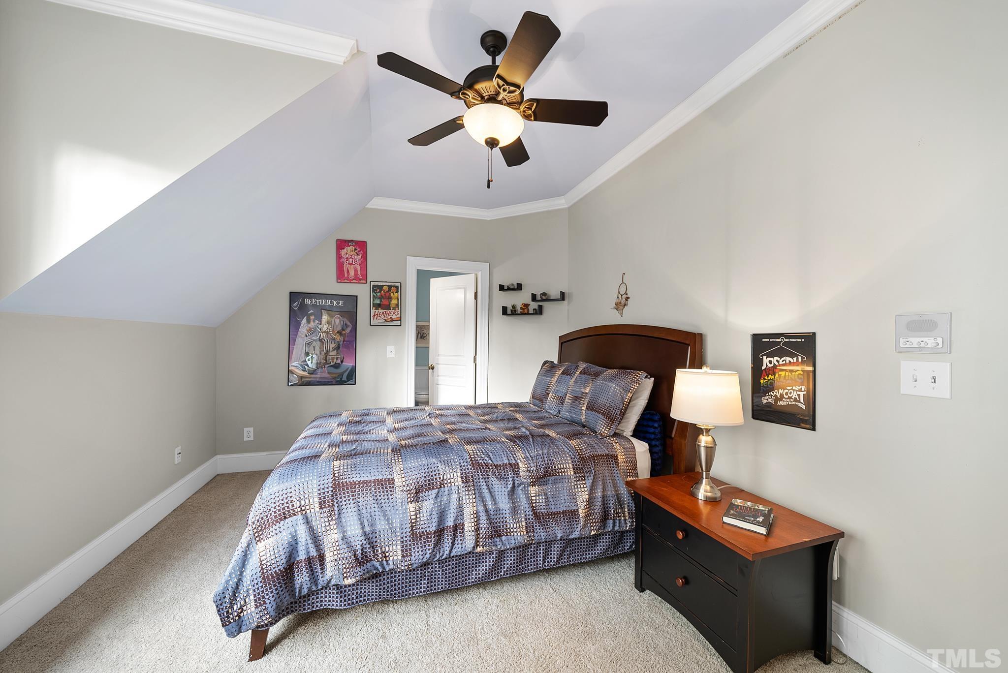 3044 Farrior Road Raleigh, NC 27607 - Photo 35 of 64 a bedroom with a bed and a chandelier