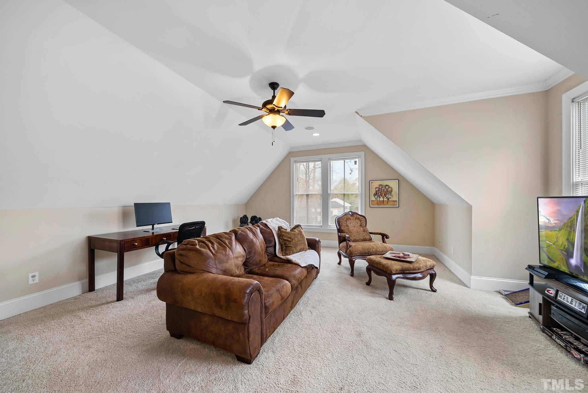 3044 Farrior Road Raleigh, NC 27607 - Photo 39 of 64 a living room with furniture and a flat screen tv