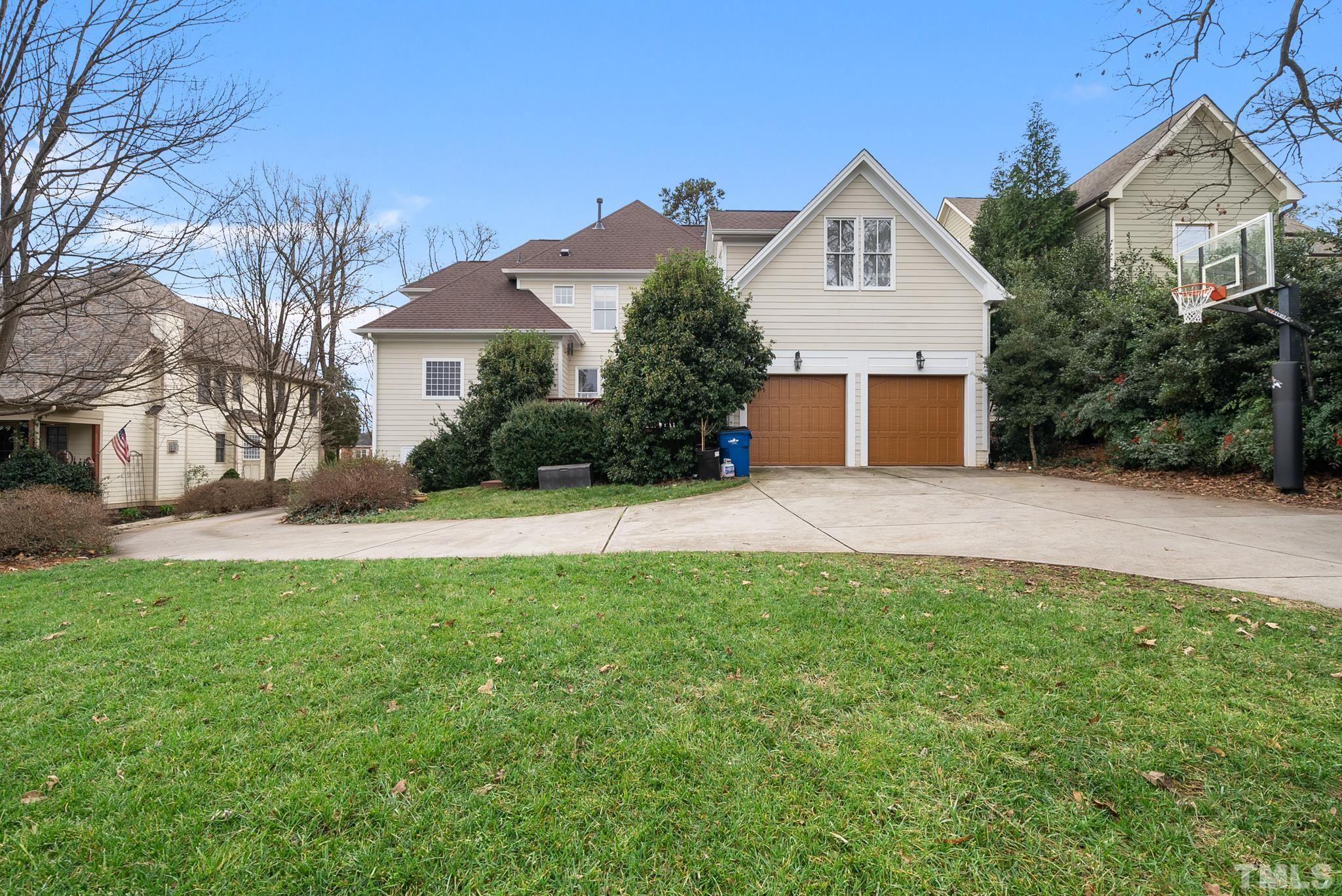 3044 Farrior Road Raleigh, NC 27607 - Photo 46 of 64 a front view of a house with a yard and garage