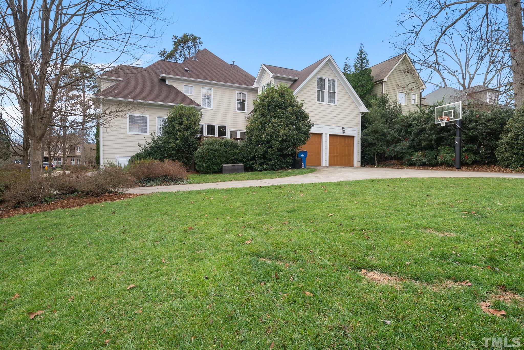 3044 Farrior Road Raleigh, NC 27607 - Photo 47 of 64 a front view of a house with a yard and garage