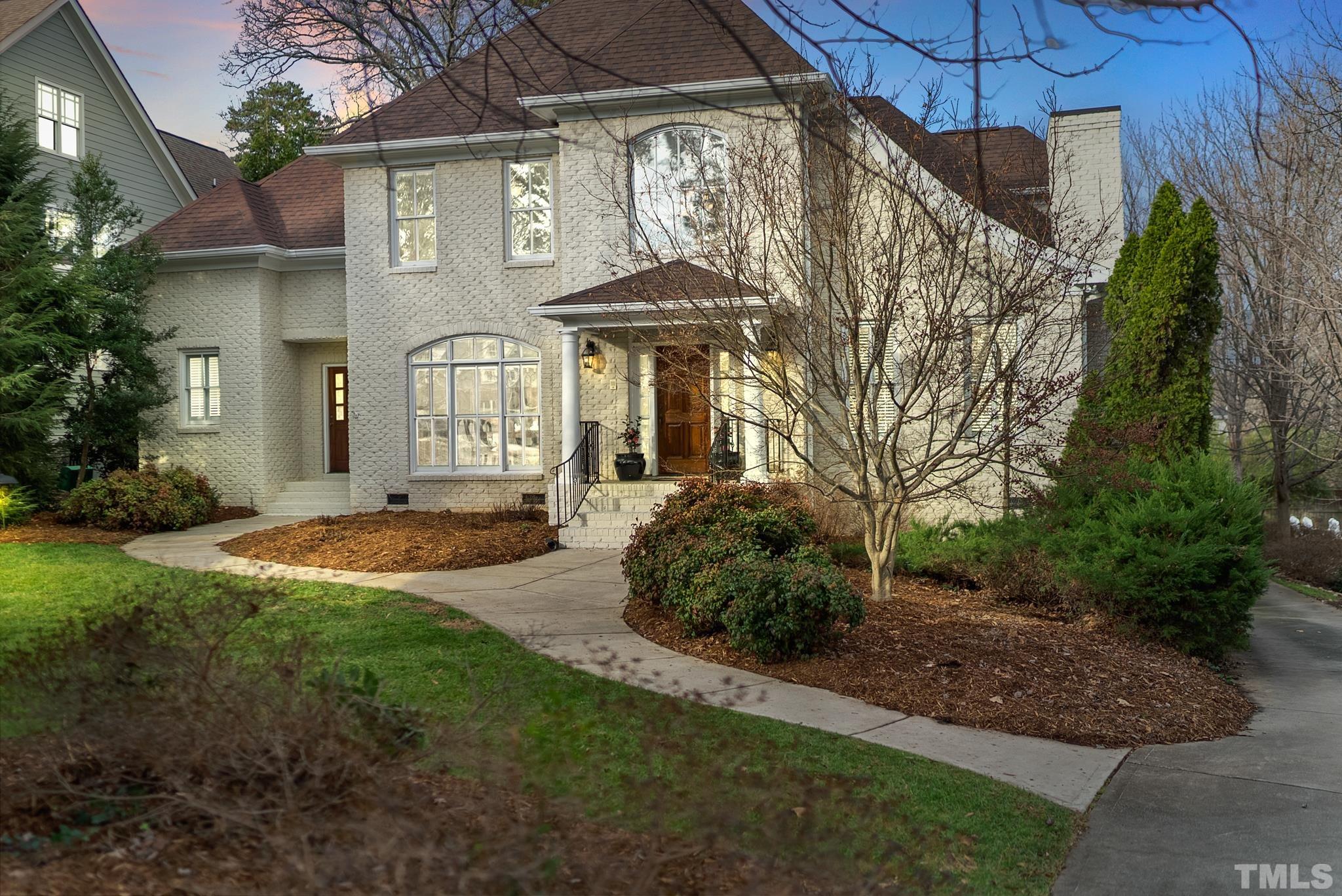 3044 Farrior Road Raleigh, NC 27607 - Photo 54 of 64 a front view of a house with a yard and potted plants