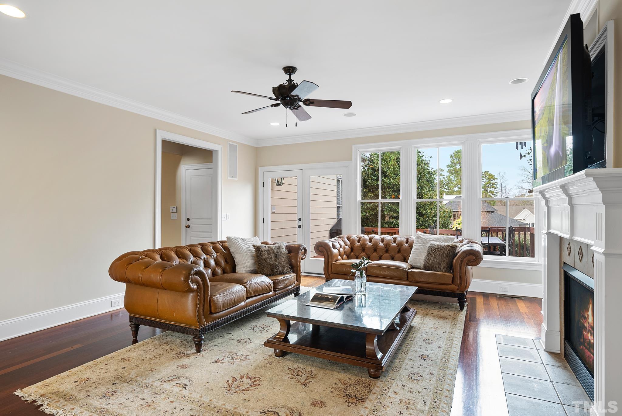 3044 Farrior Road Raleigh, NC 27607 - Photo 8 of 64 a living room with furniture fireplace and a flat screen tv