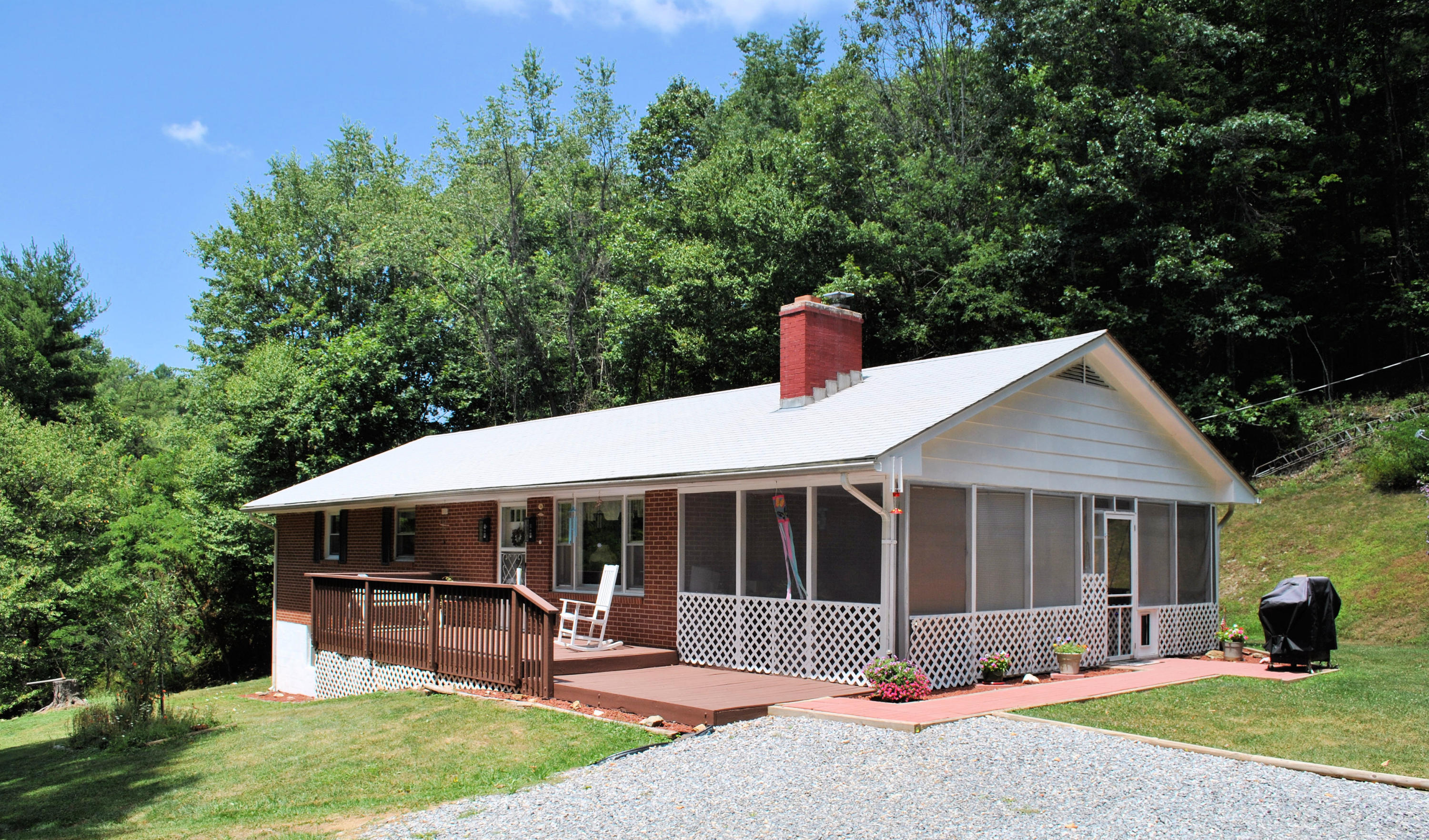 219 Berryhill Road Northwest Riner, VA 24149 - Photo 1 of 54 a front view of a house with a yard and outdoor seating