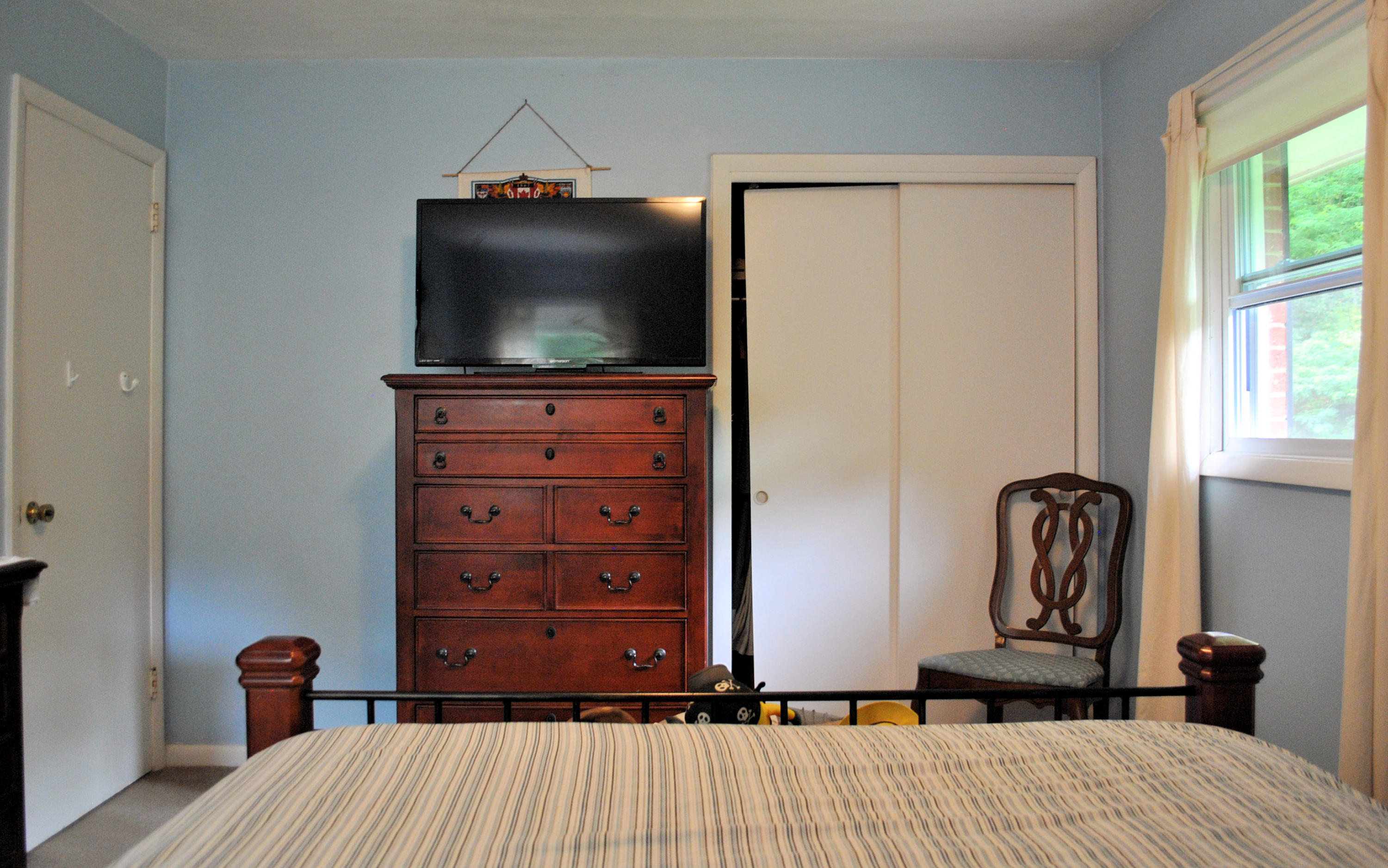 219 Berryhill Road Northwest Riner, VA 24149 - Photo 22 of 54 a bedroom with a bed and a flat tv screen on dresser
