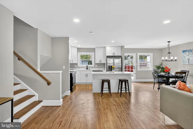 a living room with furniture dining table and wooden floor