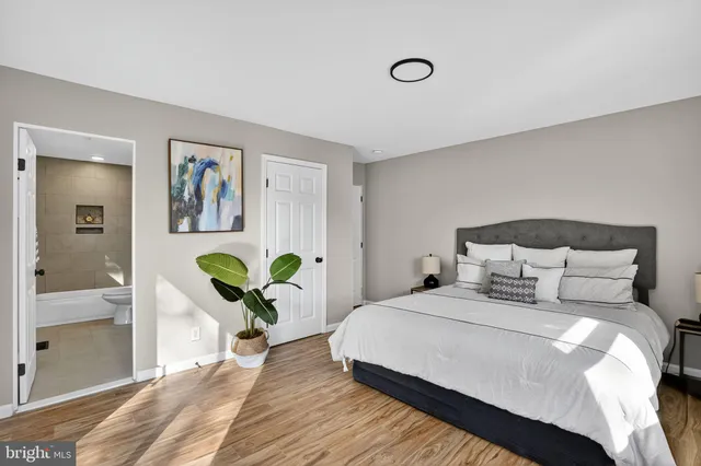 a bedroom with a bed and hallway