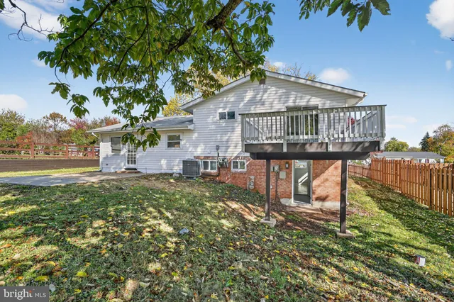 a view of a house with a yard and a porch