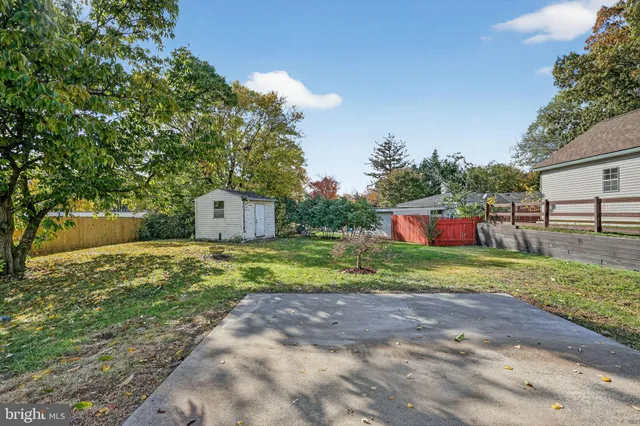a backyard of a house with a yard and outdoor seating