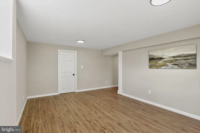a view of an empty room and wooden floor