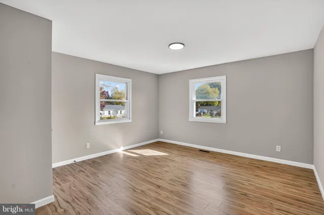 a view of a room with wooden floor and window