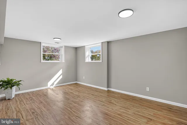 a view of a room with wooden floor and potted plant
