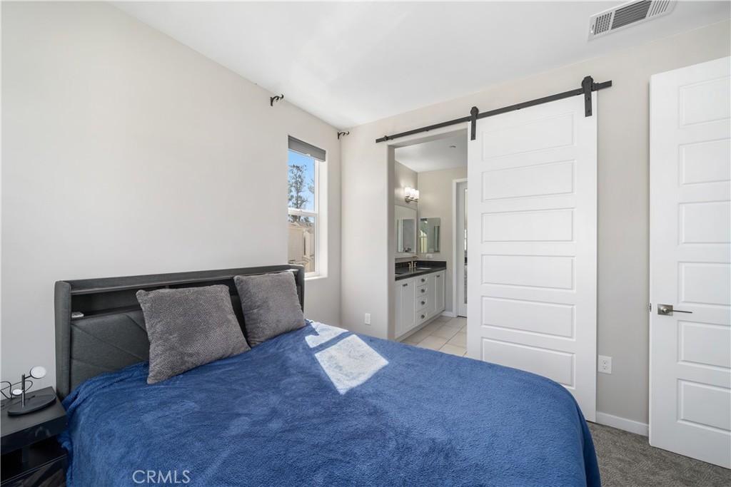 905 Madonna Road, Unit 69 San Luis Obispo, CA 93405 - Photo 12 of 26 a bedroom with a bed and a walk in closet