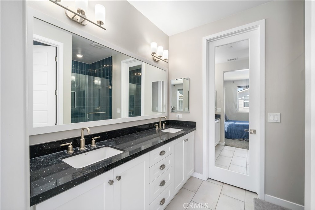 905 Madonna Road, Unit 69 San Luis Obispo, CA 93405 - Photo 13 of 26 a bathroom with a granite countertop sink and a mirror