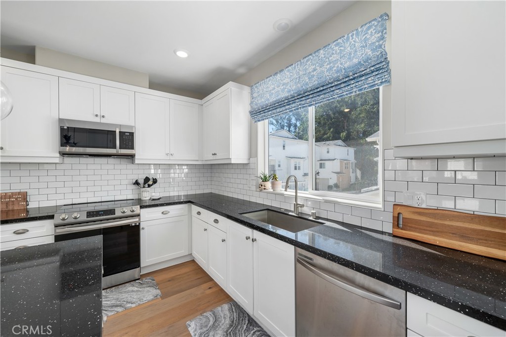 905 Madonna Road, Unit 69 San Luis Obispo, CA 93405 - Photo 2 of 26 a kitchen with stainless steel appliances granite countertop a sink stove and cabinets