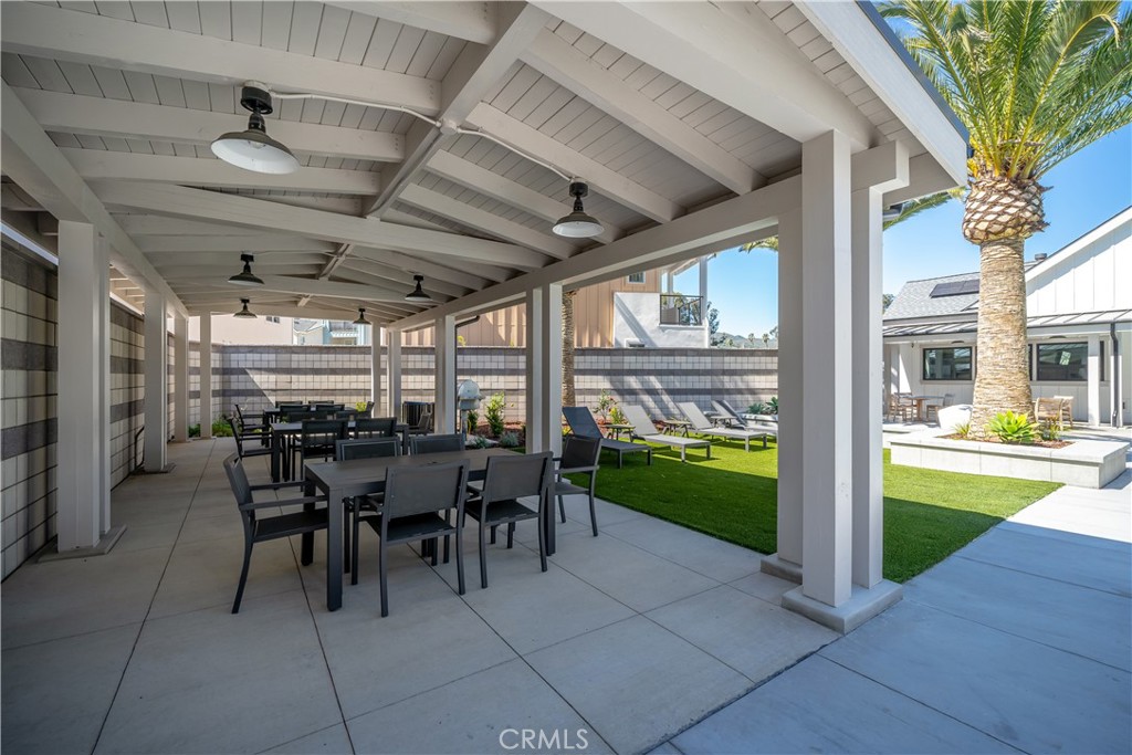 905 Madonna Road, Unit 69 San Luis Obispo, CA 93405 - Photo 25 of 26 a view of a patio with table and chairs next to a yard