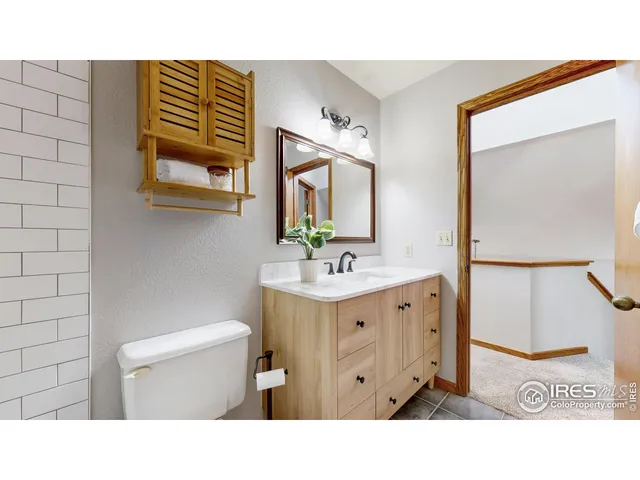 a bathroom with a sink a toilet and mirror