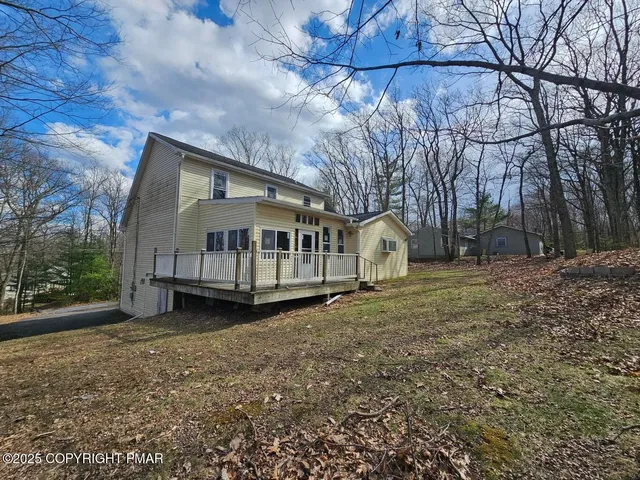 a house that has a tree in front of it