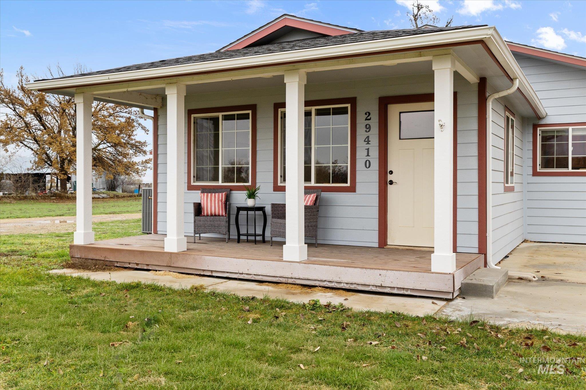 29410 Pearl Road Parma, ID 83660 - Photo 11 of 50 Entrance to property featuring covered porch, a lawn, and roof with shingles