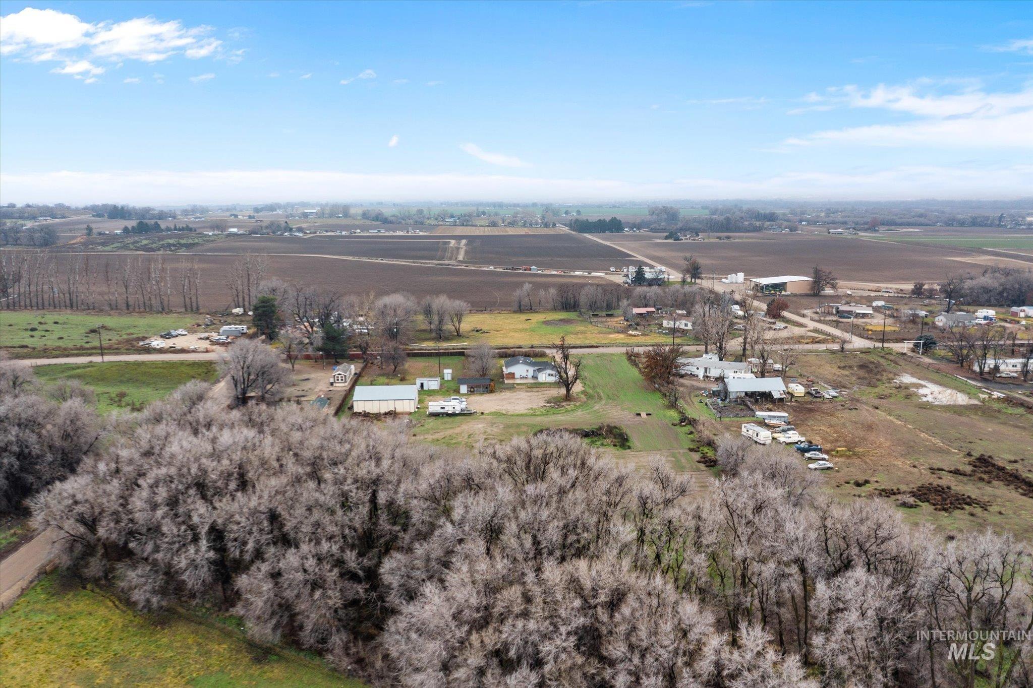 29410 Pearl Road Parma, ID 83660 - Photo 33 of 50 Aerial view of property and surrounding area with rural landscape and rows of crops