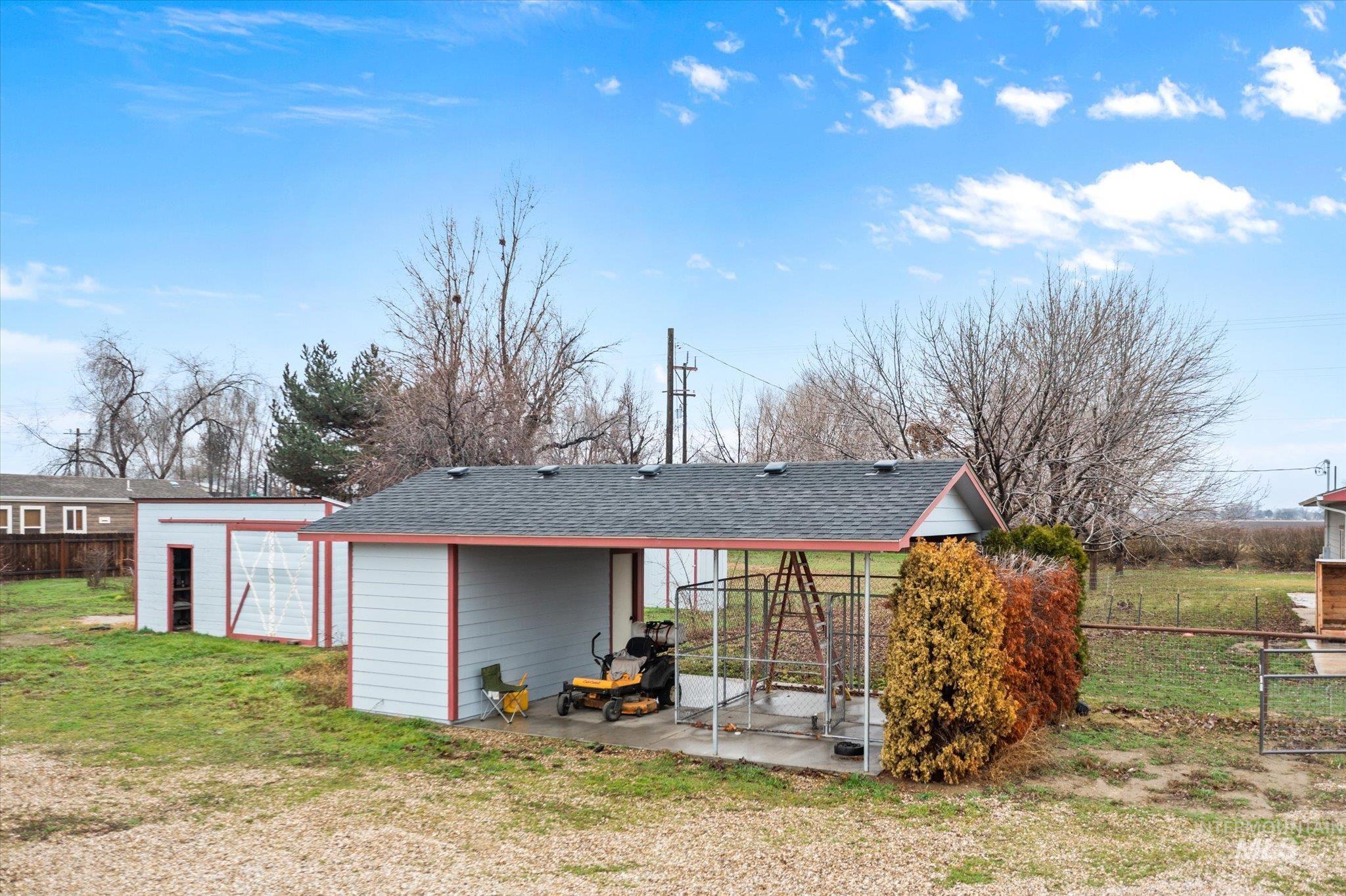 29410 Pearl Road Parma, ID 83660 - Photo 9 of 50 Back of property featuring roof with shingles and an outbuilding