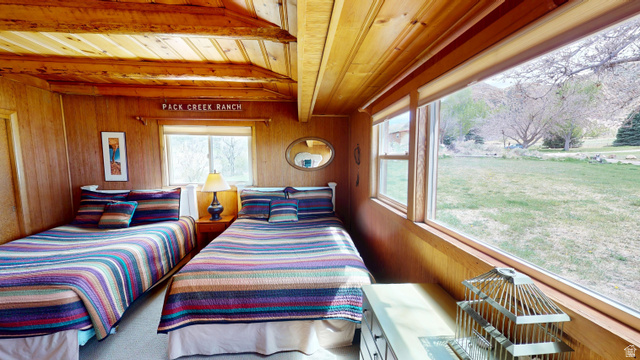 315 Abbey Road Moab, UT 84532 - Photo 33 of 46 Bedroom featuring wooden walls and a wooden ceiling with exposed beams