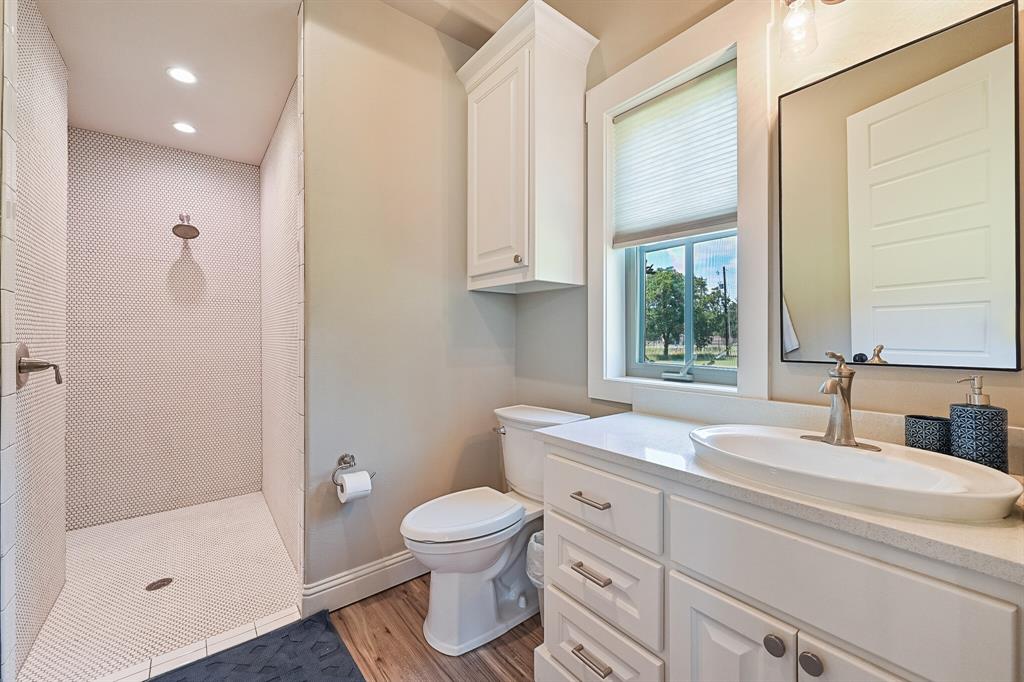 7120 Shady Grove Road Keller, TX 76248 - Photo 34 of 40 a bathroom with a sink toilet and shower