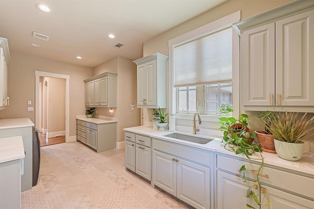 7120 Shady Grove Road Keller, TX 76248 - Photo 37 of 40 a kitchen with sink refrigerator and cabinets
