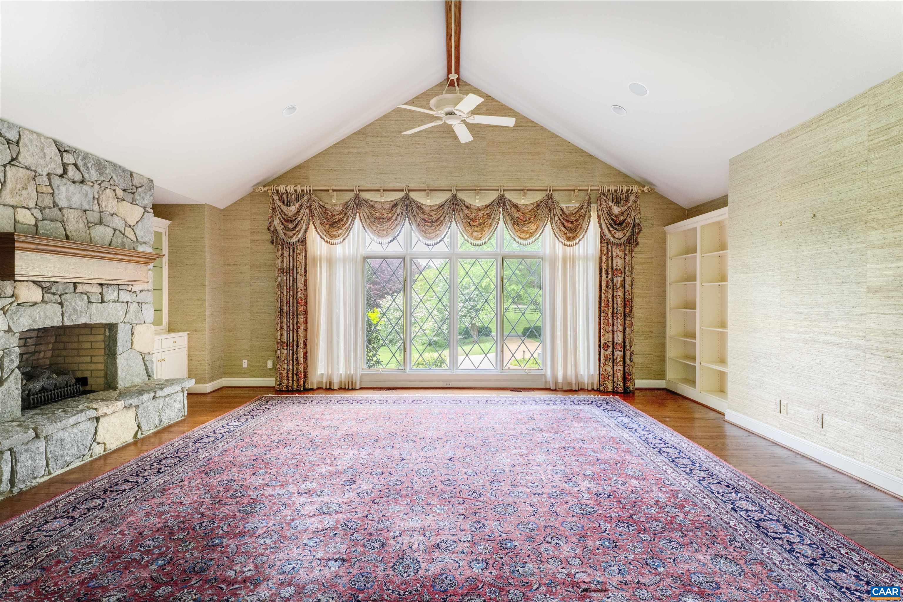 2121 Garth Road Charlottesville, VA 22901 - Photo 19 of 75 a view of an empty room with a fireplace and a window