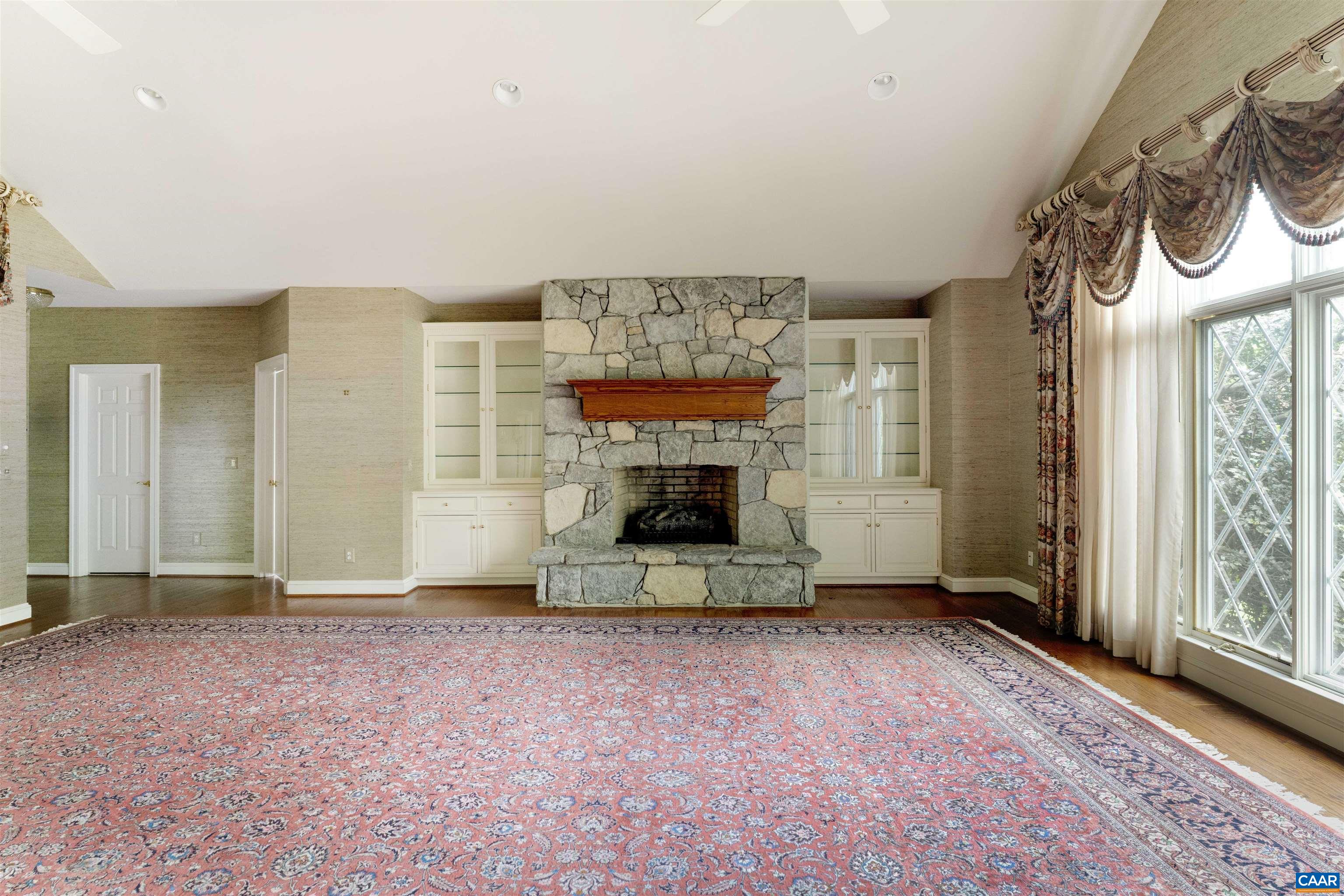 2121 Garth Road Charlottesville, VA 22901 - Photo 20 of 75 a view of an empty room with a fireplace and a window