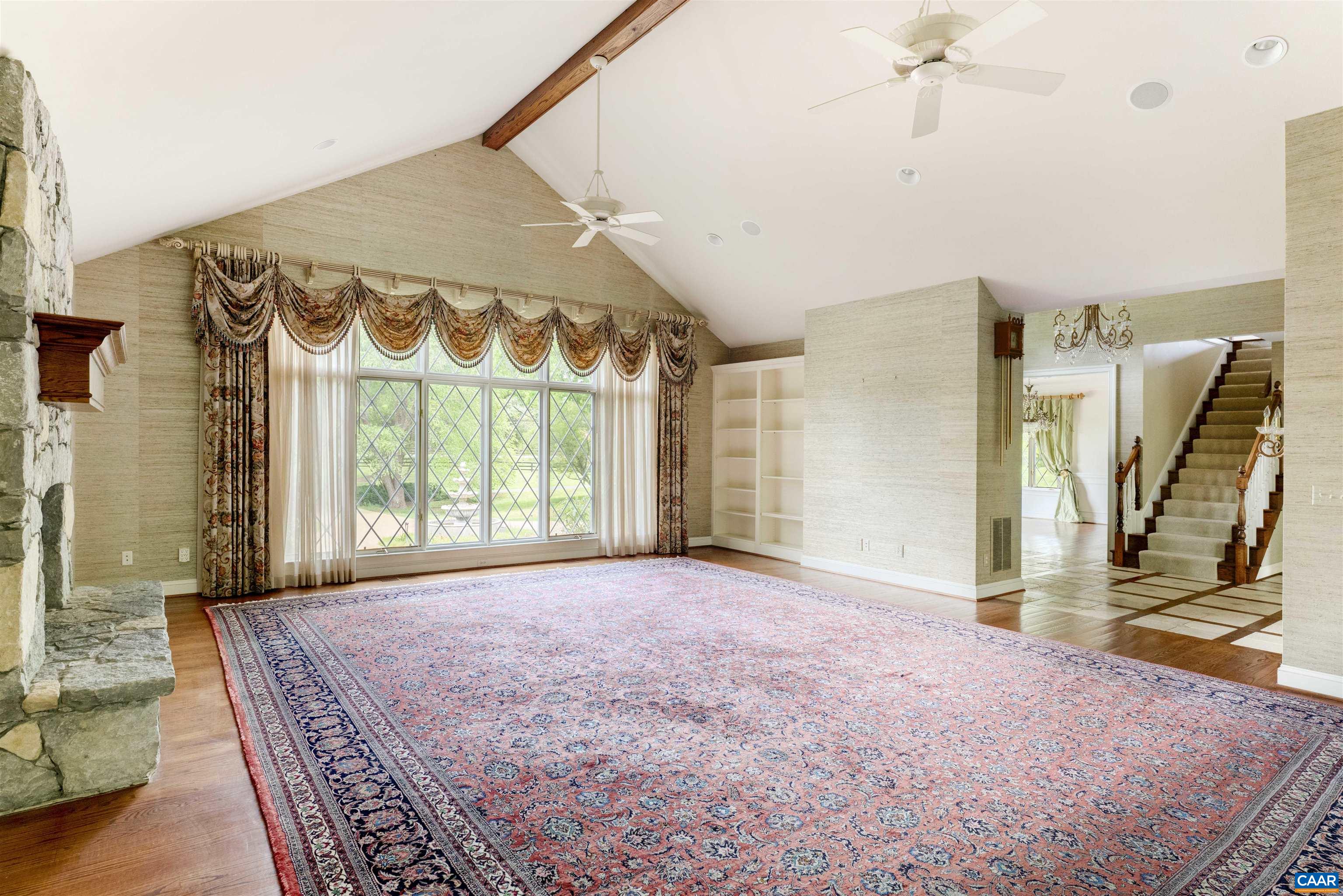 2121 Garth Road Charlottesville, VA 22901 - Photo 21 of 75 a view of an empty room with a fireplace and a window