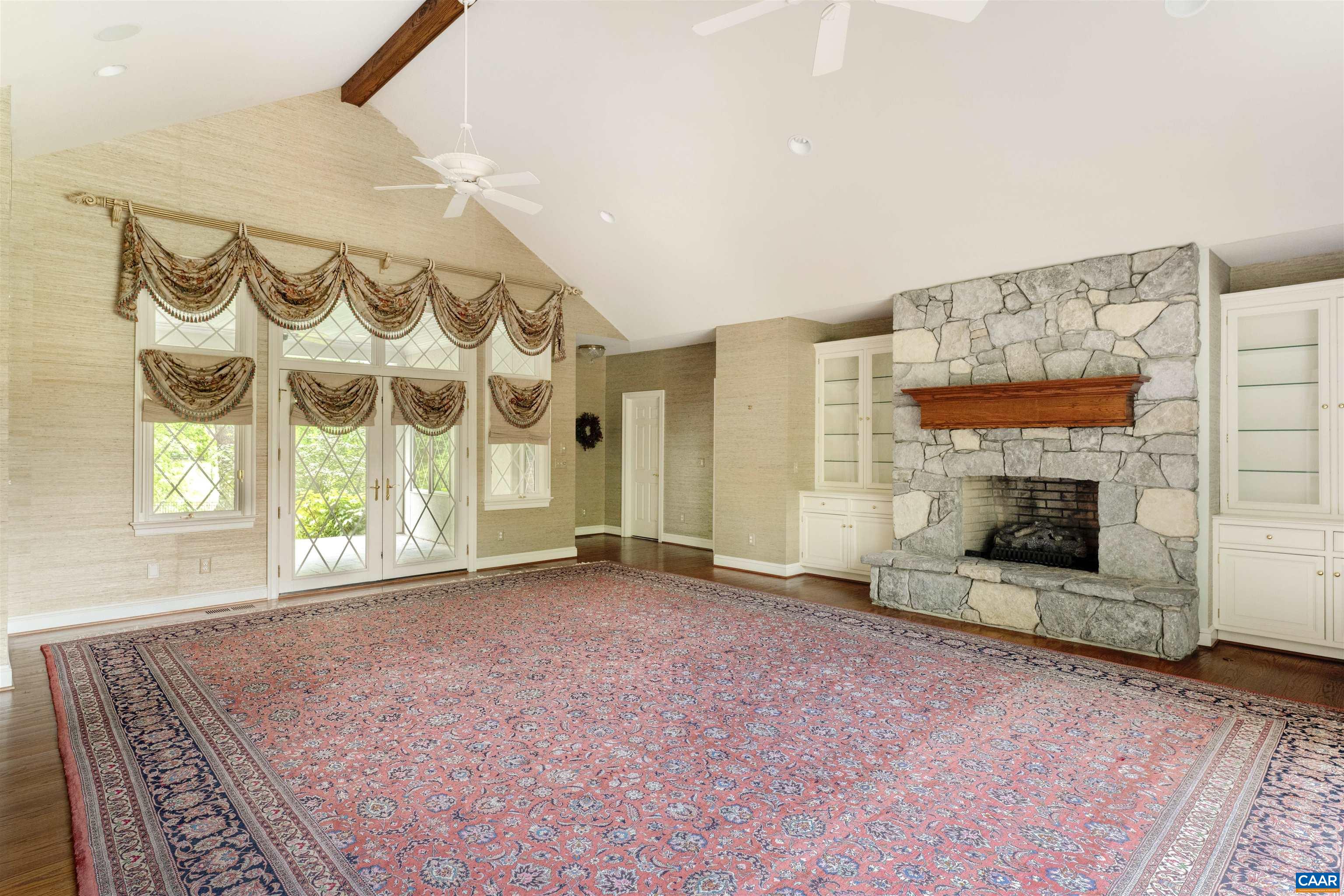 2121 Garth Road Charlottesville, VA 22901 - Photo 22 of 75 a view of an empty room with a fireplace and a window