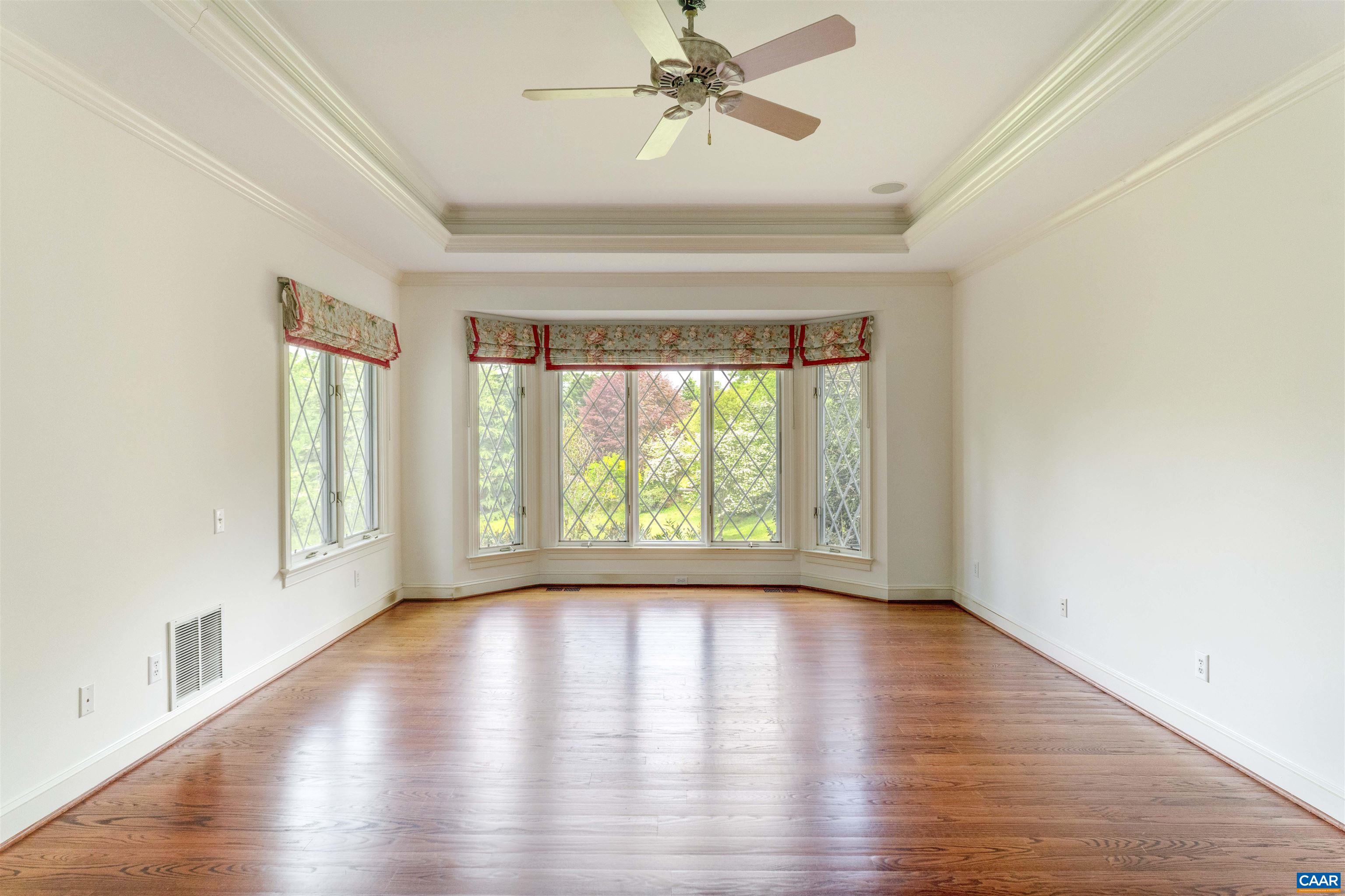 2121 Garth Road Charlottesville, VA 22901 - Photo 23 of 75 a view of an empty room with wooden floor and a window